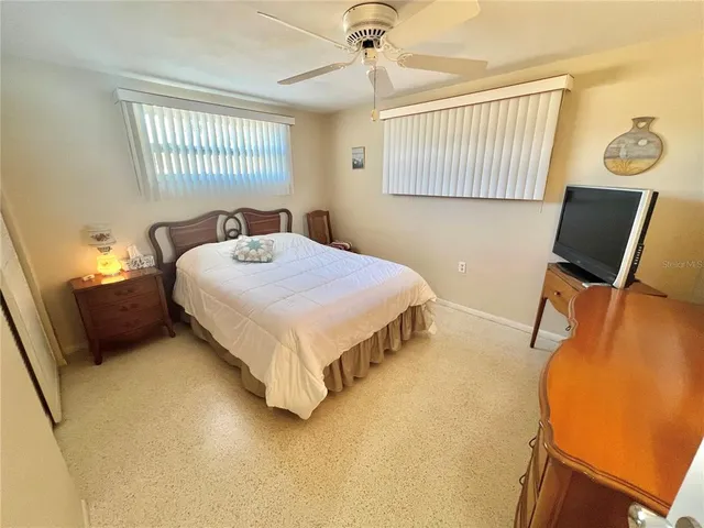 a bedroom with a bed and a mirror