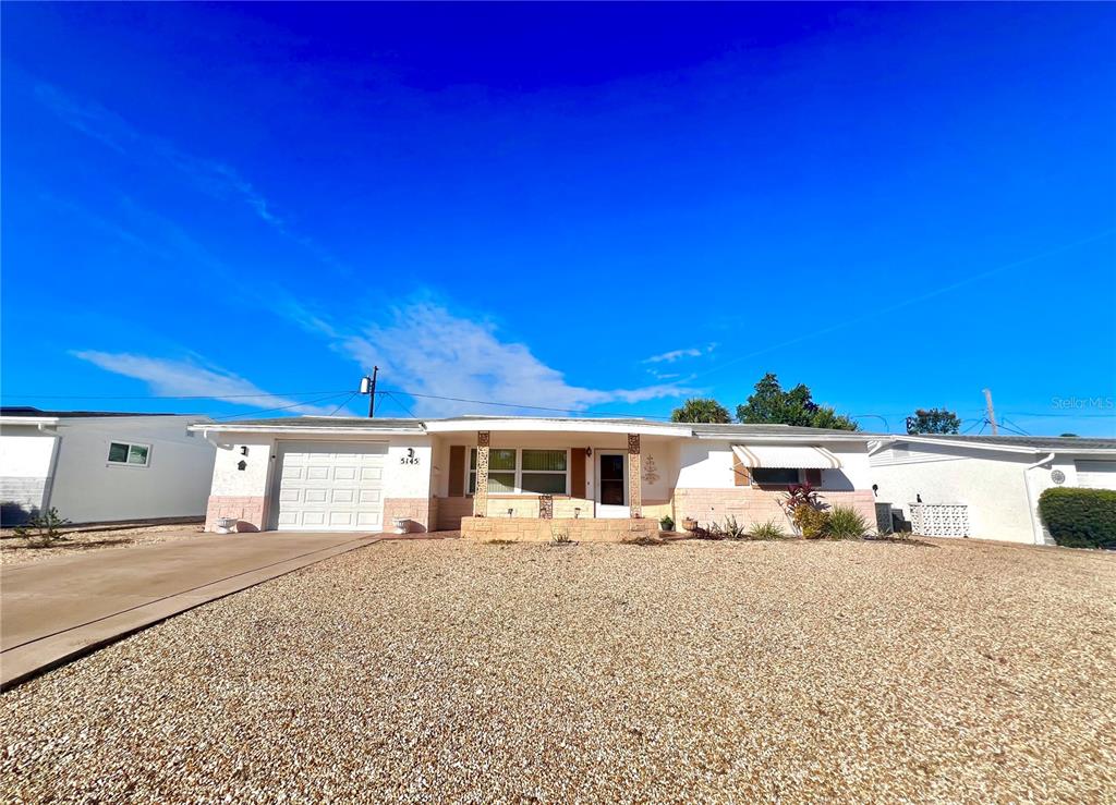5145 Cicero Drive New Port Richey, FL 34652 - Photo 2 of 19 a view of a house with a big yard