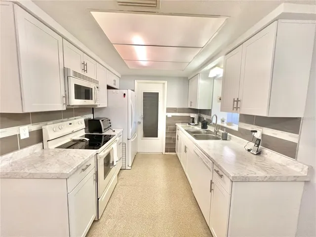 a kitchen with a sink stove and refrigerator