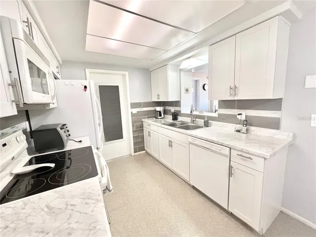 a kitchen with a stove a sink and a refrigerator