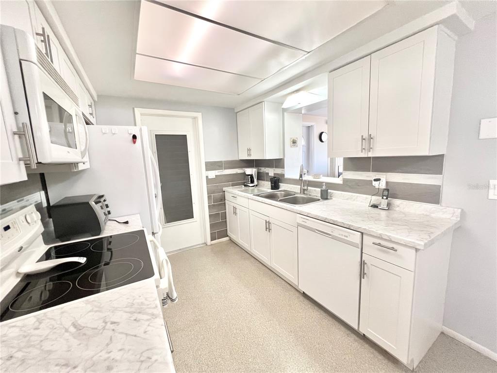 5145 Cicero Drive New Port Richey, FL 34652 - Photo 6 of 19 a kitchen with a sink stove and refrigerator