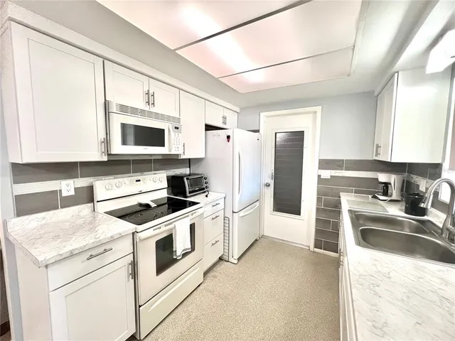 a view of a dining room with furniture and a chandelier