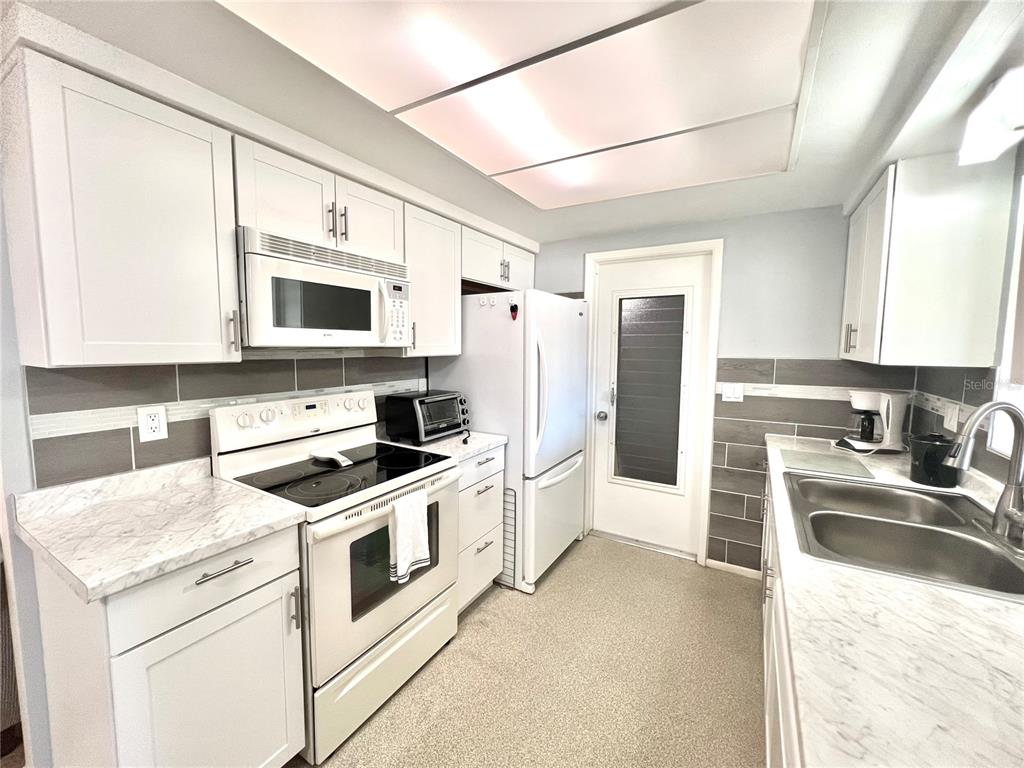 5145 Cicero Drive New Port Richey, FL 34652 - Photo 7 of 19 a kitchen with a stove a sink and a refrigerator