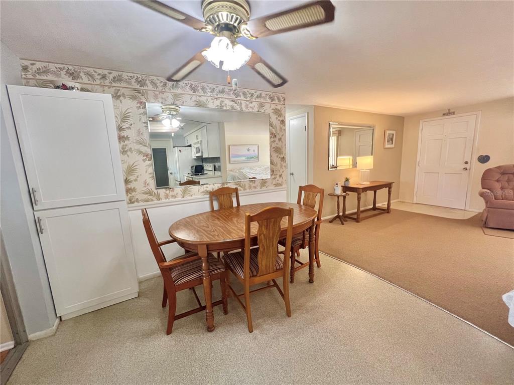 5145 Cicero Drive New Port Richey, FL 34652 - Photo 8 of 19 a view of a dining room with furniture and a chandelier