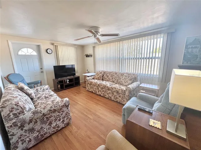 a living room with furniture and a lamp