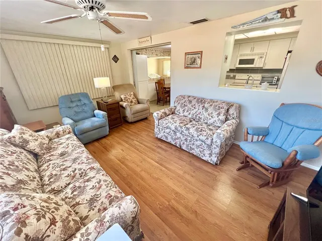 a bedroom with a bed wooden floor and window