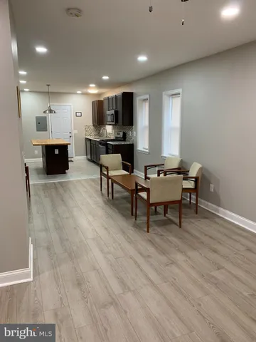 a living room with furniture and kitchen view