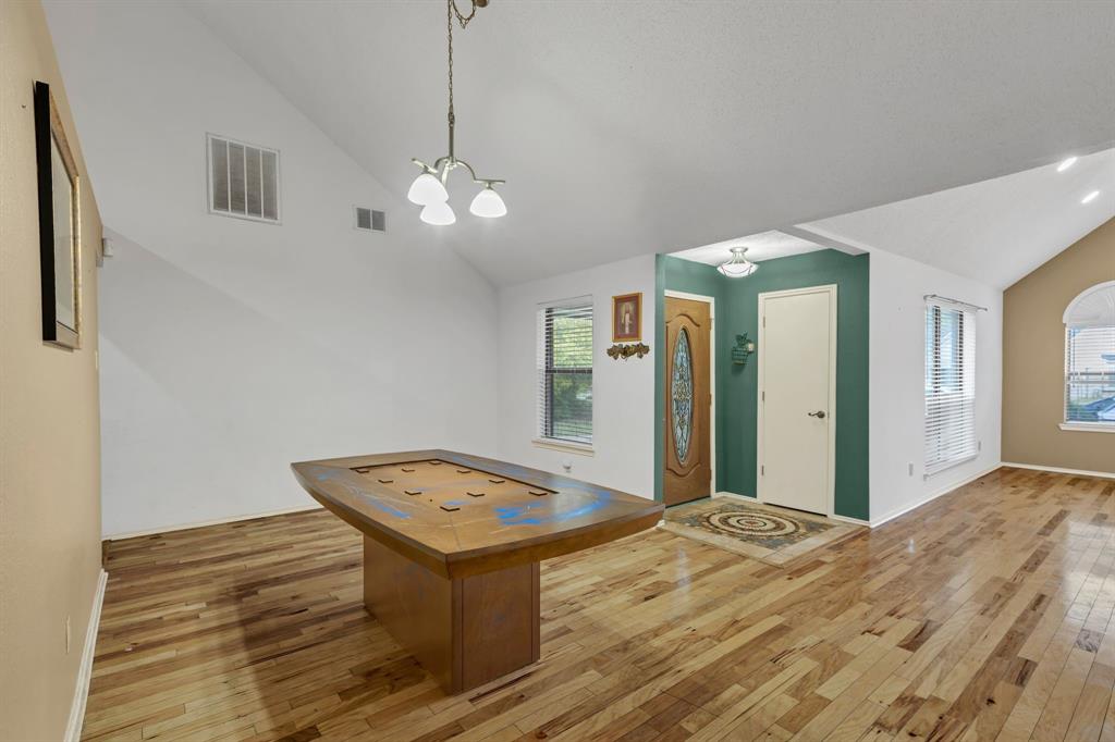 8405 Spinnaker Cove Rowlett, TX 75089 - Photo 11 of 30 a view of a room with a chandelier and wooden floor