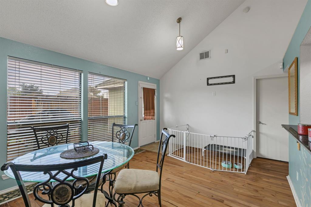 8405 Spinnaker Cove Rowlett, TX 75089 - Photo 15 of 30 a view of a dining room with furniture and wooden floor