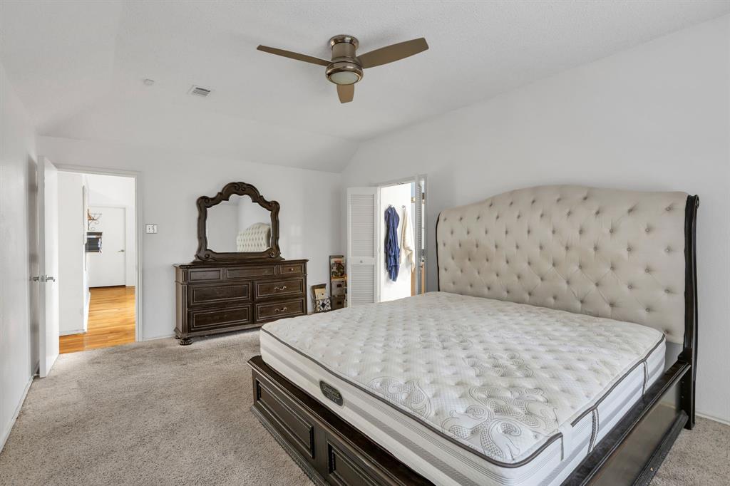 8405 Spinnaker Cove Rowlett, TX 75089 - Photo 18 of 30 a bedroom with a bed and dresser