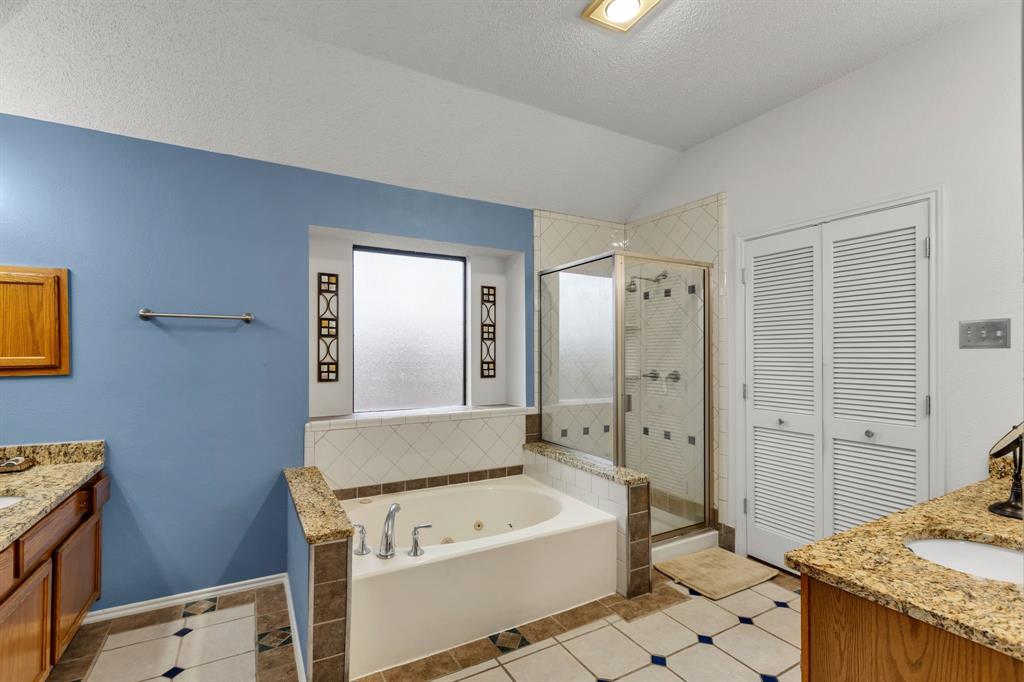 8405 Spinnaker Cove Rowlett, TX 75089 - Photo 20 of 30 a bathroom with a tub sink and mirror