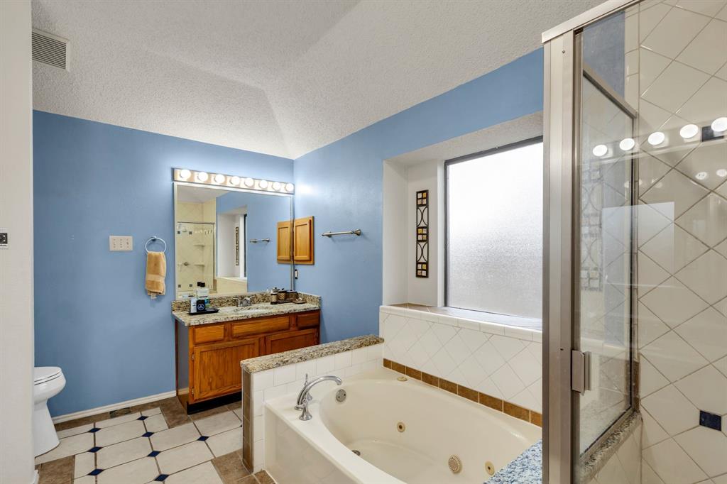 8405 Spinnaker Cove Rowlett, TX 75089 - Photo 21 of 30 a bathroom with a sink toilet and shower