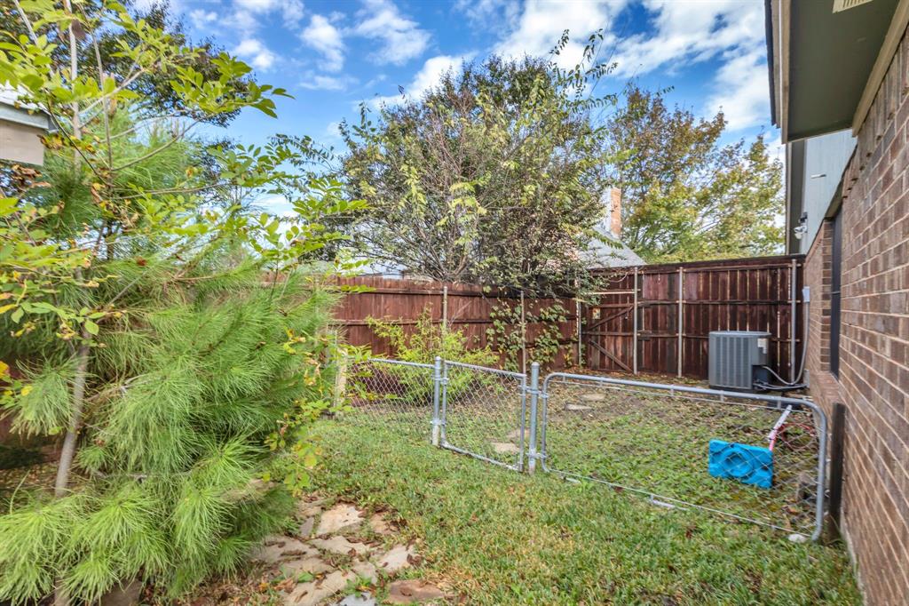 8405 Spinnaker Cove Rowlett, TX 75089 - Photo 27 of 30 a backyard of a house with table and chairs