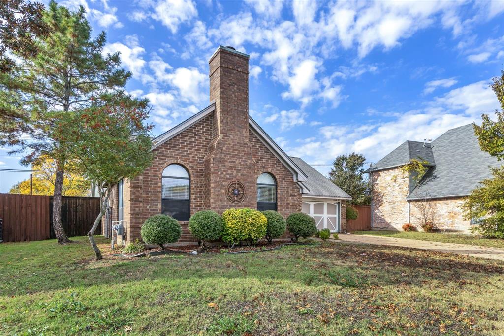 8405 Spinnaker Cove Rowlett, TX 75089 - Photo 3 of 30 a front view of a house with garden