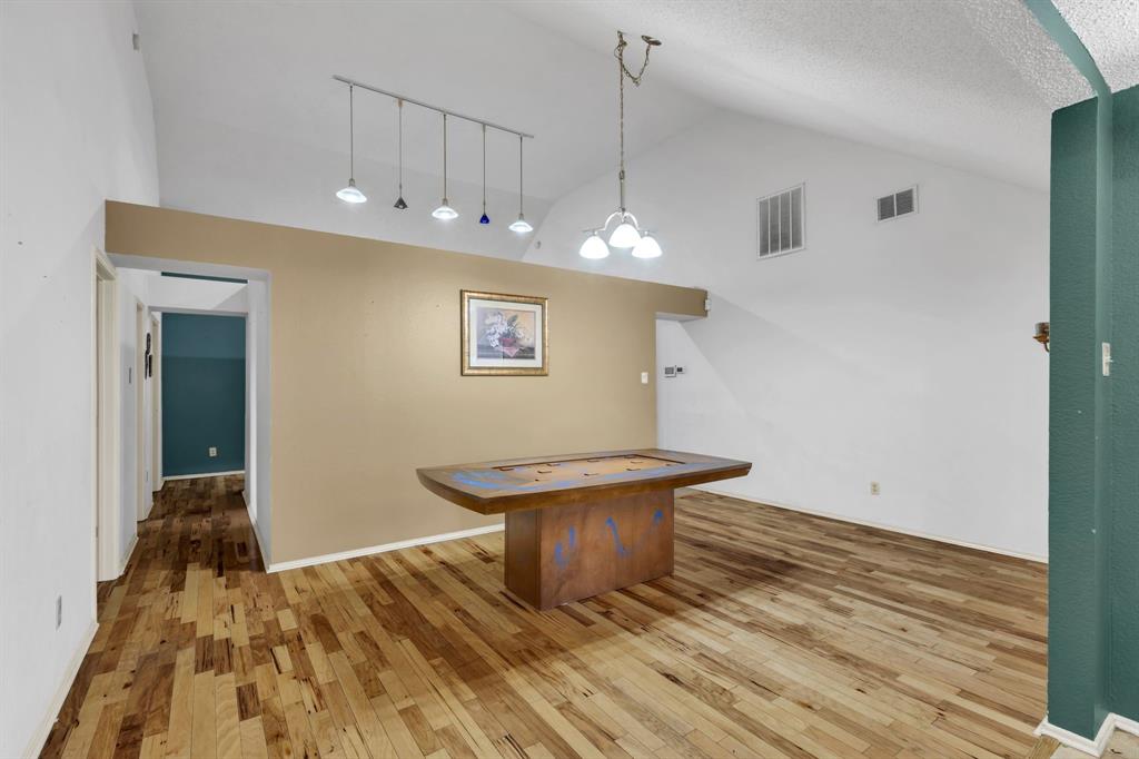 8405 Spinnaker Cove Rowlett, TX 75089 - Photo 10 of 30 a view of a hallway with wooden floor and a fireplace