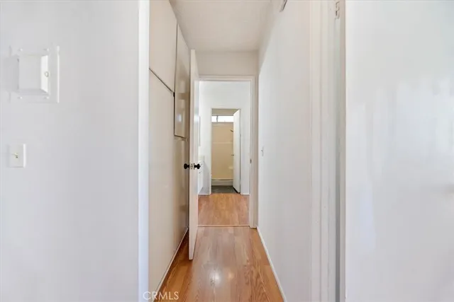 a view of a hallway with wooden floor
