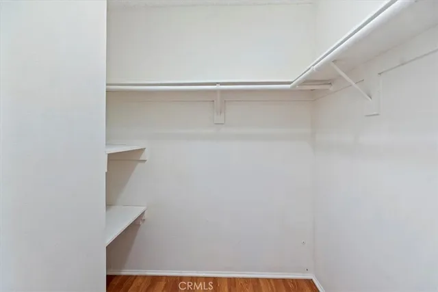 a view of walk in closet with empty racks