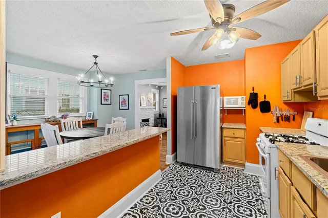 a kitchen with stainless steel appliances granite countertop a refrigerator a oven a sink and dishwasher