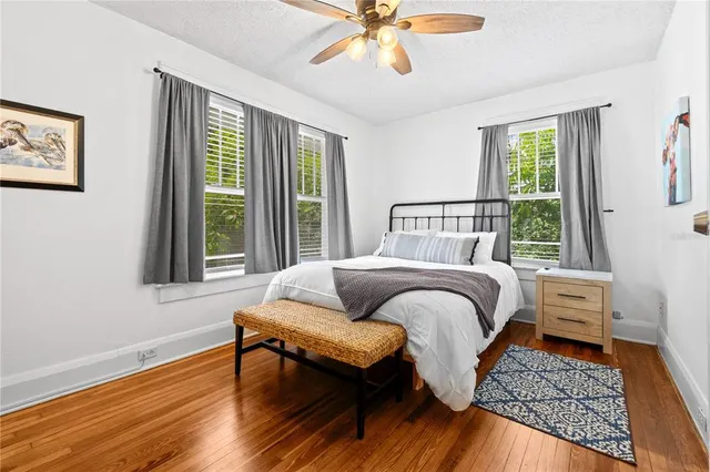 a bedroom with furniture and wooden floor
