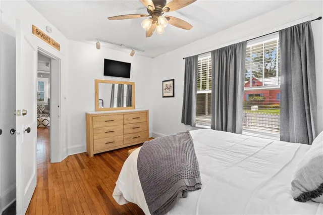 a bedroom with a bed and a flat tv screen