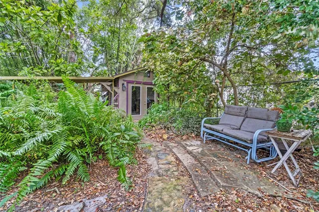 a backyard of a house with lots of green space and a fountain