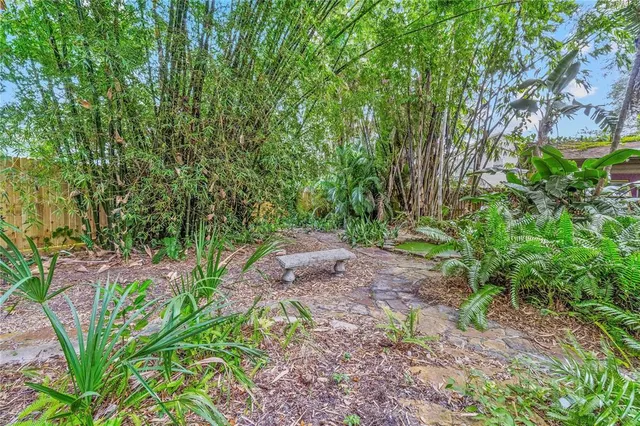 a view of a swimming pool with lawn chairs under an umbrella