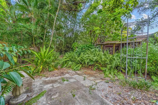 a view of a patio with table and chairs under an umbrella