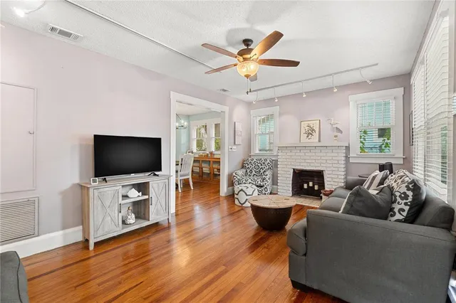 a living room with furniture a flat screen tv and a fireplace