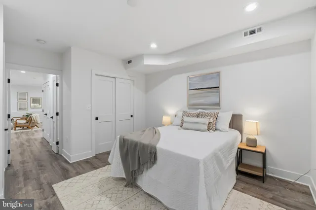 a room with a bed and a view of living room