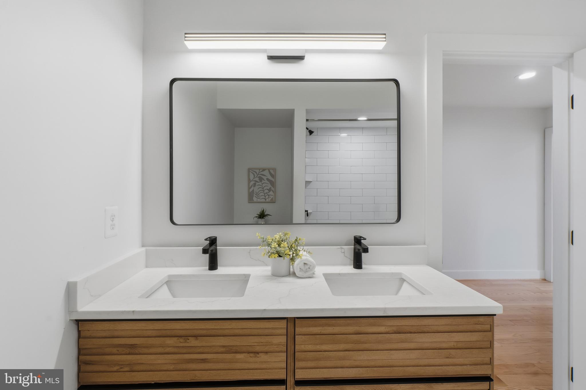 3923 Roland Avenue Baltimore, MD 21211 - Photo 23 of 30 a bathroom with a sink vanity and a mirror