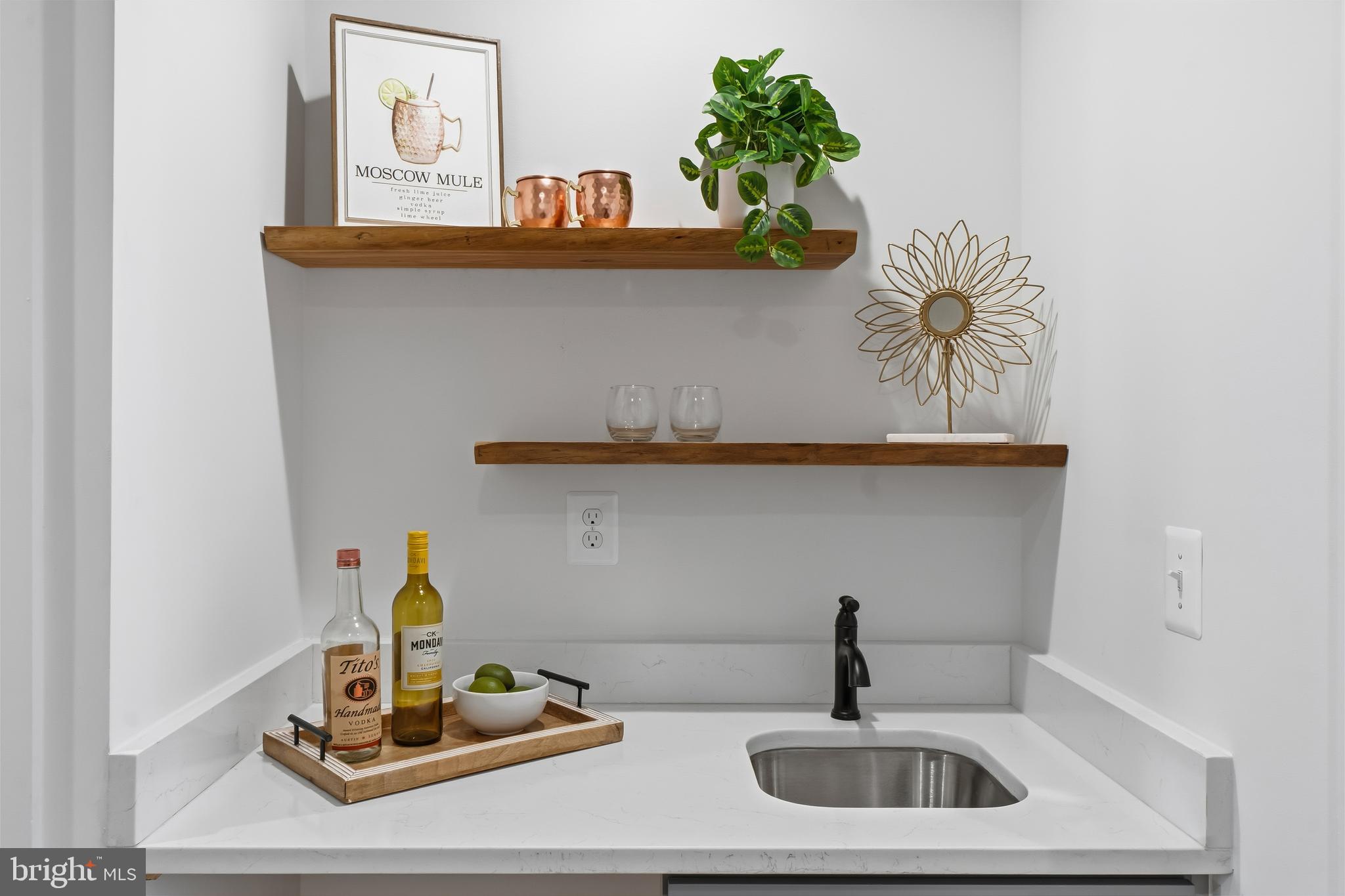 3923 Roland Avenue Baltimore, MD 21211 - Photo 26 of 30 a kitchen with a sink and a stove with wooden floor