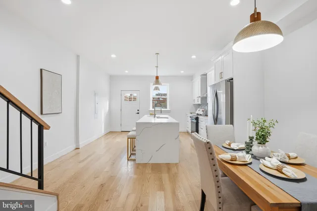 a dining room with furniture and wooden floor