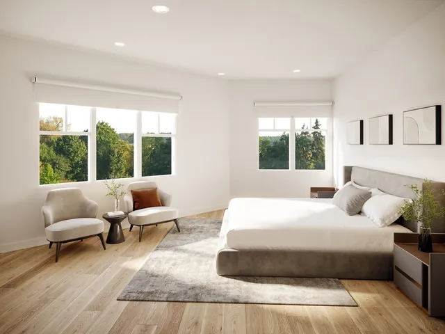 a bedroom with bed and a large window
