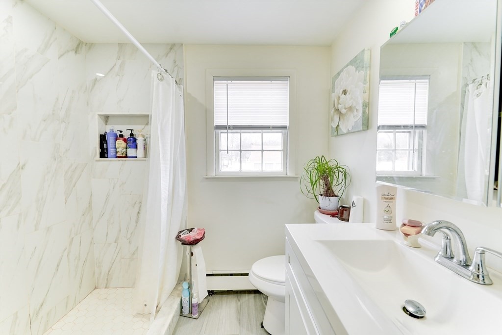 22 Clark Street Randolph, MA 02368 - Photo 11 of 26 a bathroom with a sink toilet and window