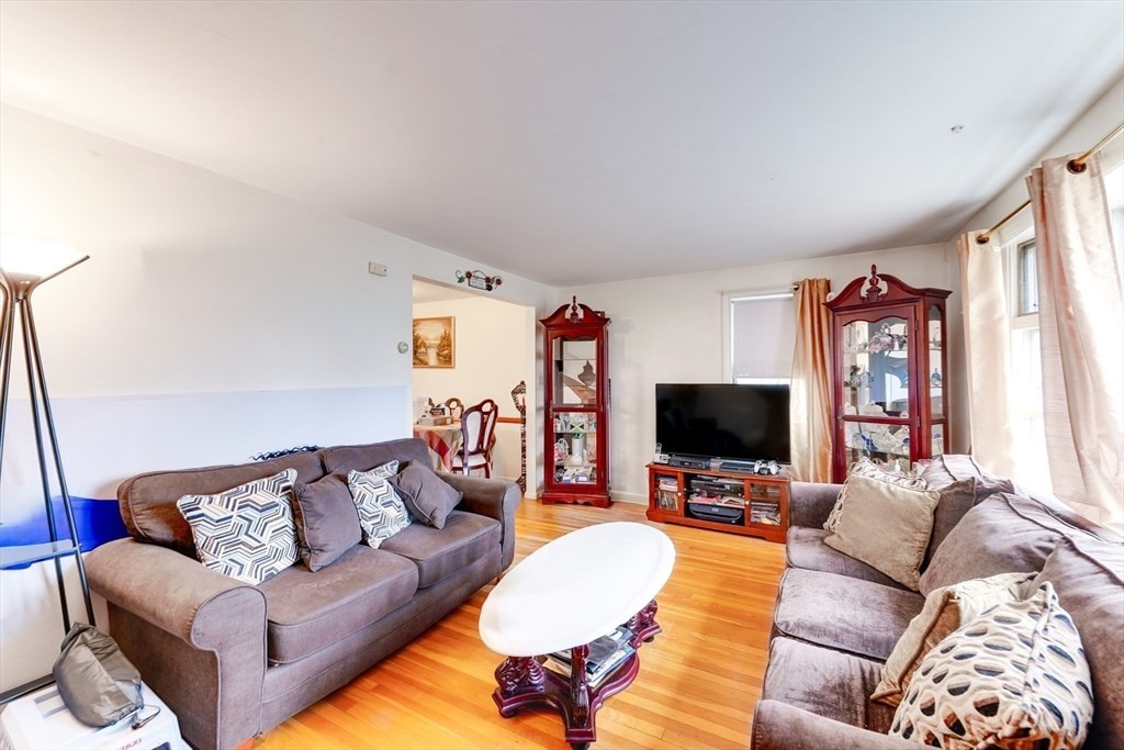 22 Clark Street Randolph, MA 02368 - Photo 18 of 26 a living room with furniture and a flat screen tv