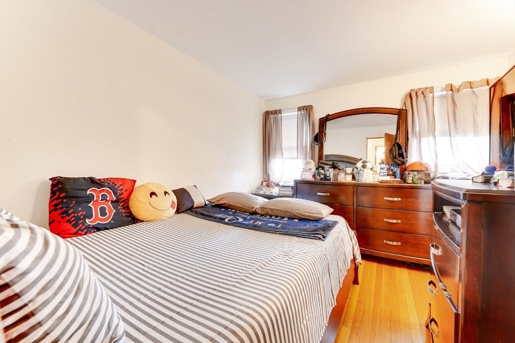 22 Clark Street Randolph, MA 02368 - Photo 19 of 26 a bedroom with a bed and a night stand