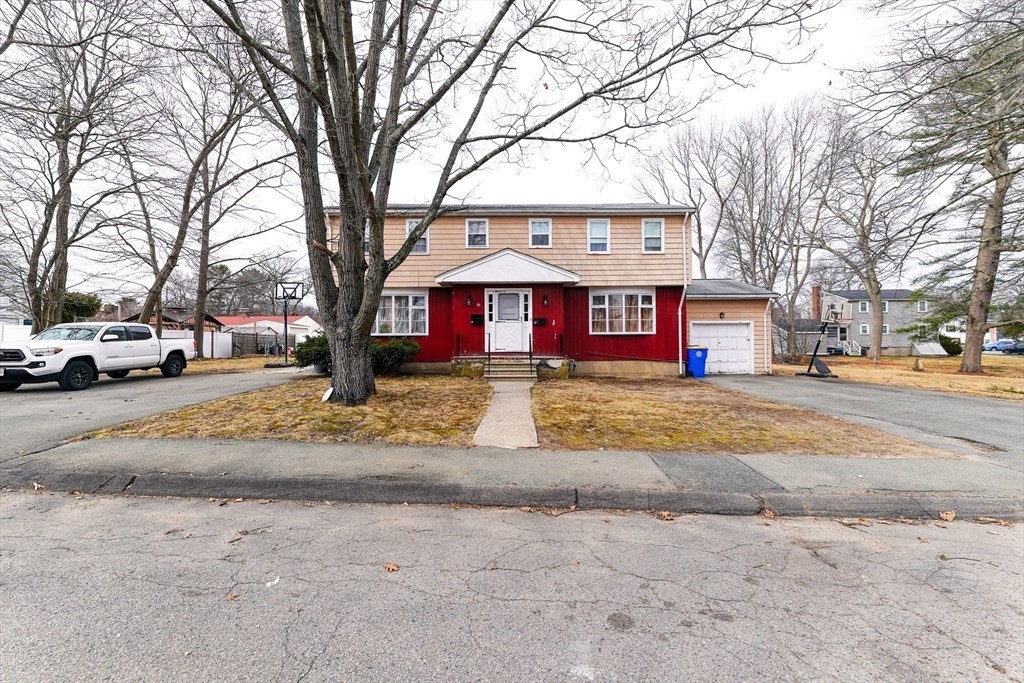 22 Clark Street Randolph, MA 02368 - Photo 2 of 26 a front view of a building with trees and cars
