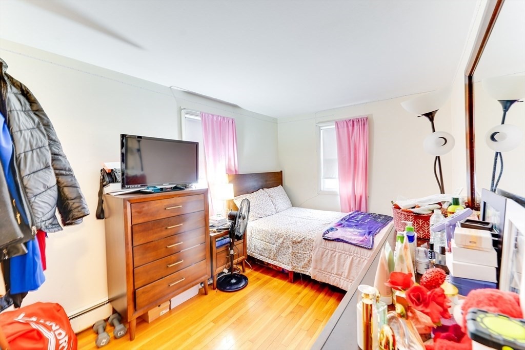 22 Clark Street Randolph, MA 02368 - Photo 21 of 26 a bedroom with a bed and flat screen tv