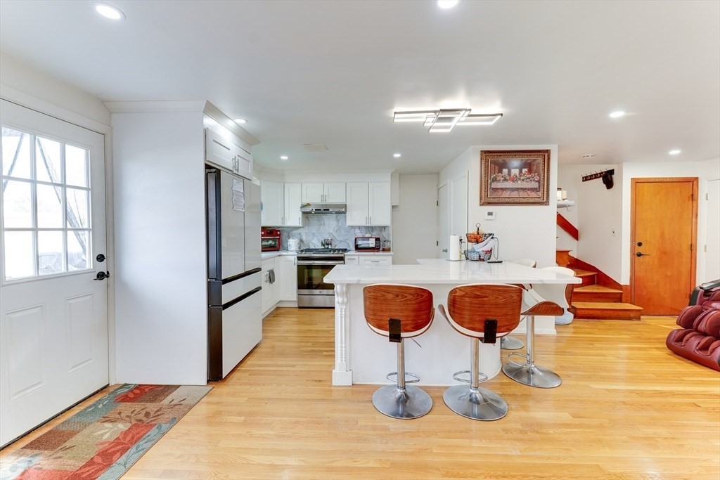 22 Clark Street Randolph, MA 02368 - Photo 6 of 26 a kitchen with stainless steel appliances granite countertop a refrigerator and a sink