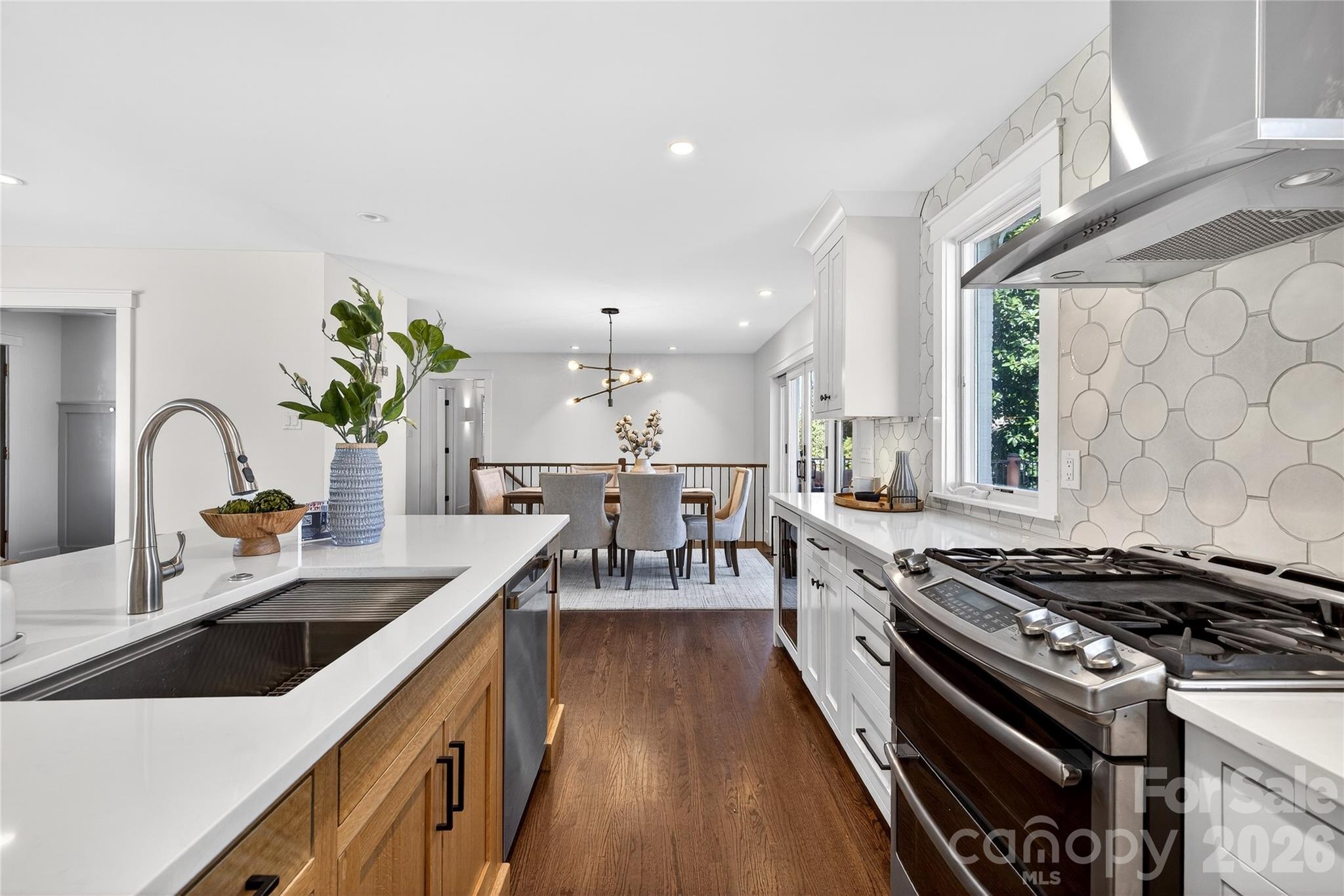 3717 Riverbend Road Charlotte, NC 28210 - Photo 14 of 41 a kitchen with stove a sink and cabinets