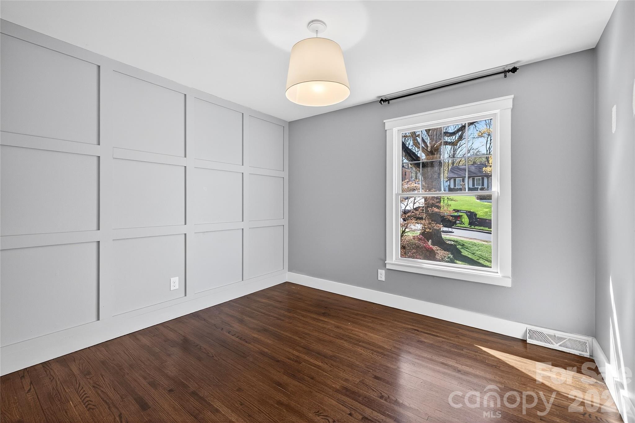 3717 Riverbend Road Charlotte, NC 28210 - Photo 26 of 41 a view of an empty room with window and wooden floor