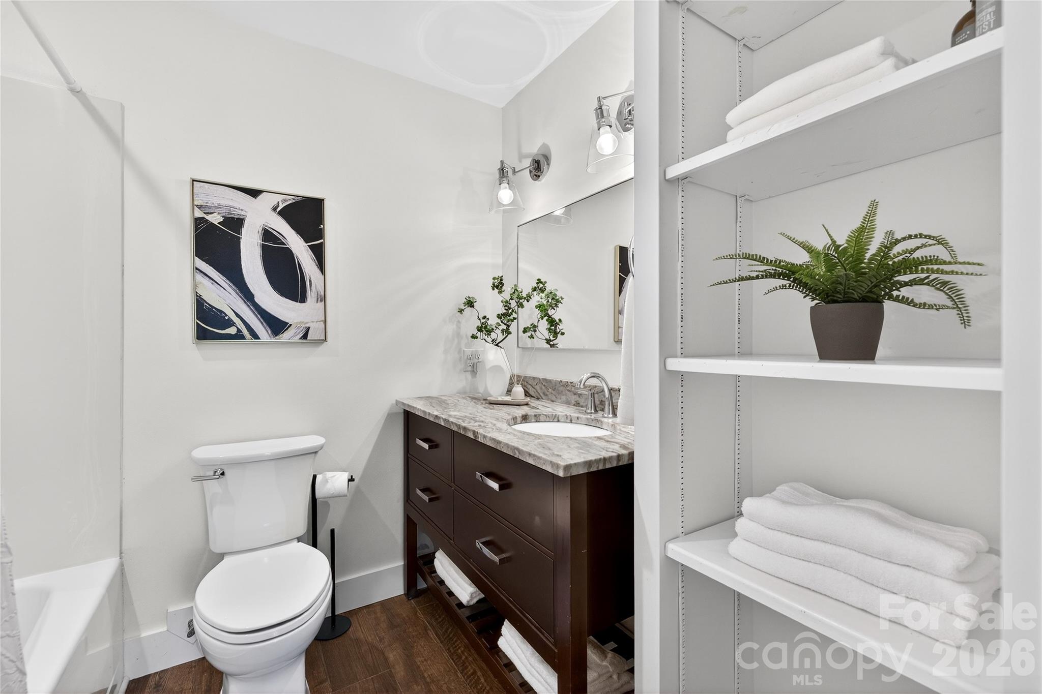 3717 Riverbend Road Charlotte, NC 28210 - Photo 27 of 41 a bathroom with a toilet a sink and mirror