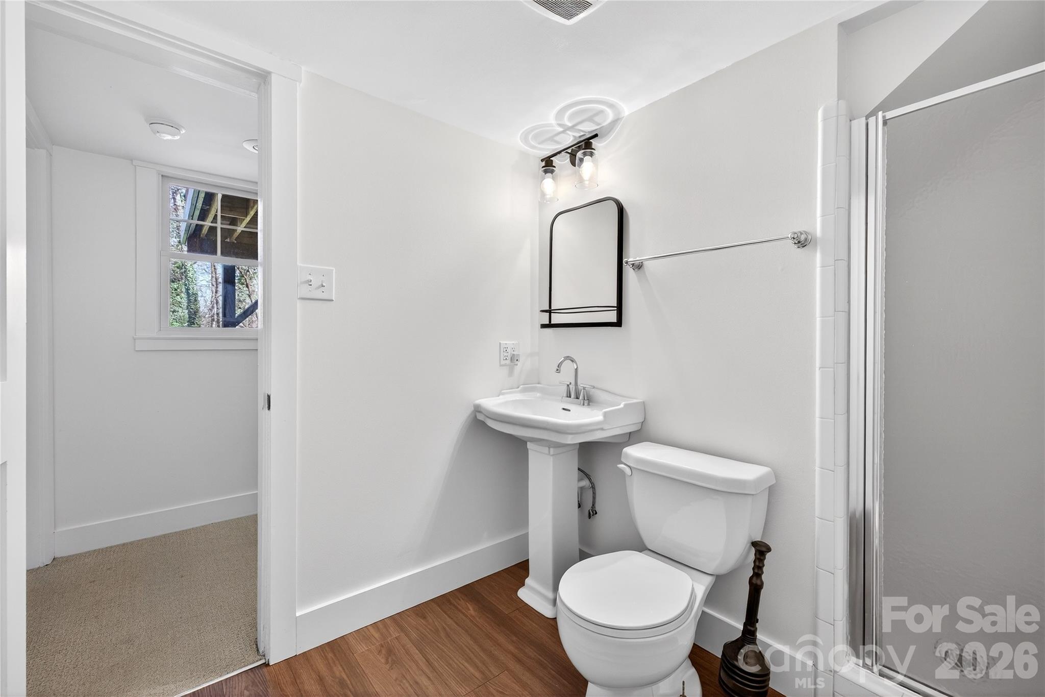 3717 Riverbend Road Charlotte, NC 28210 - Photo 29 of 41 a bathroom with a toilet sink and mirror