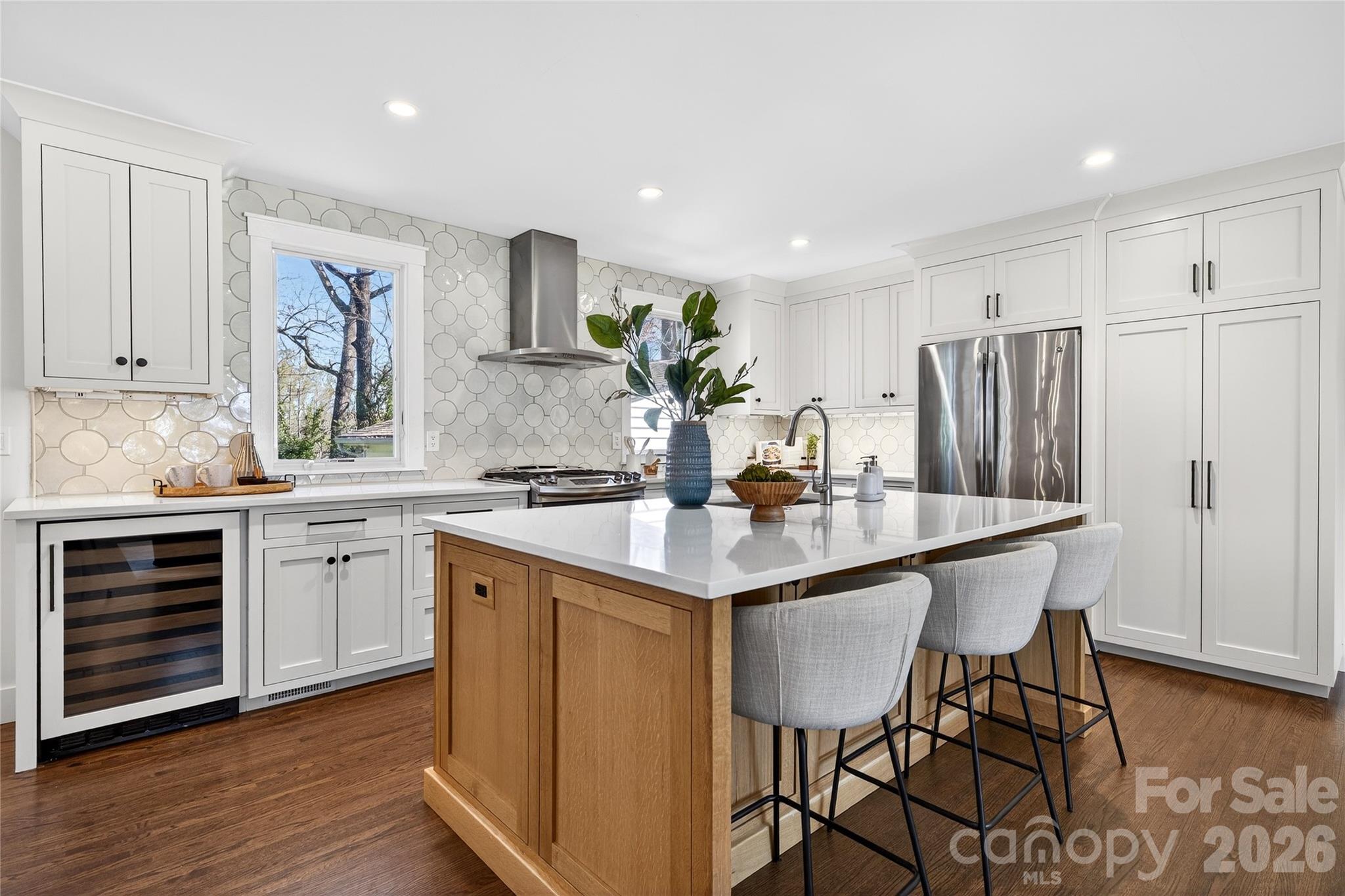 3717 Riverbend Road Charlotte, NC 28210 - Photo 3 of 41 a kitchen with a table chairs refrigerator and cabinets