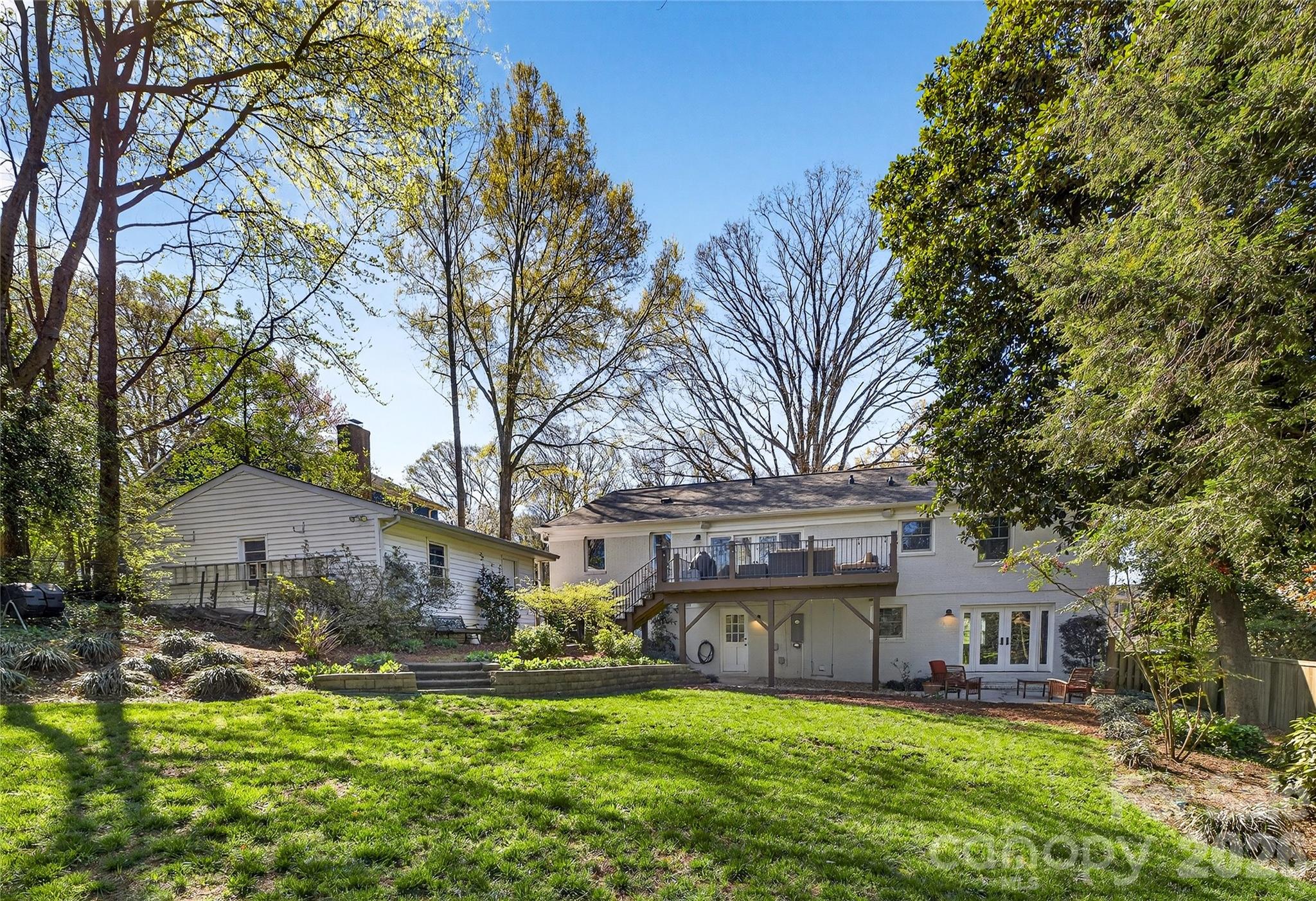 3717 Riverbend Road Charlotte, NC 28210 - Photo 37 of 41 a view of a house with a big yard and large trees