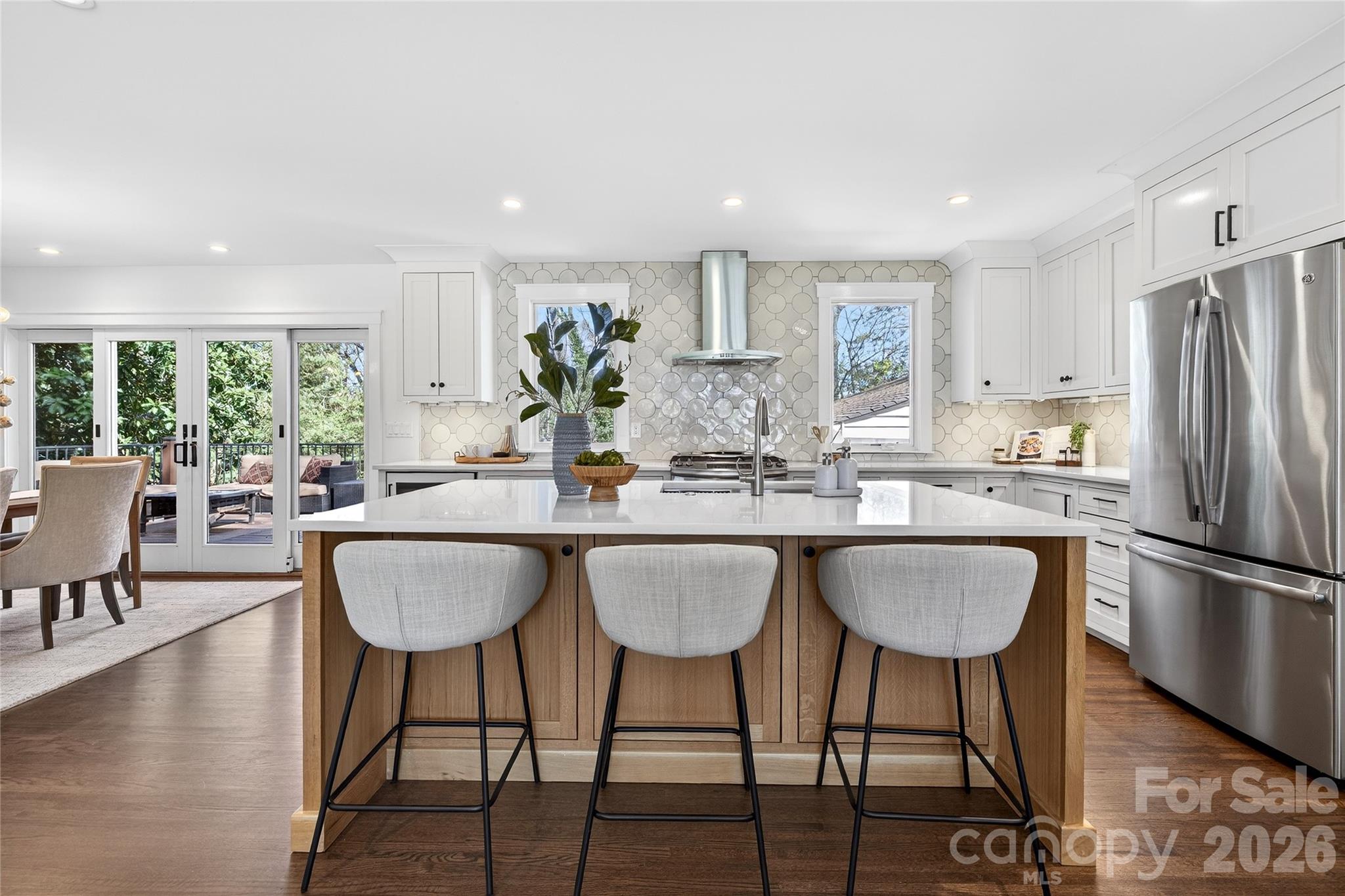 3717 Riverbend Road Charlotte, NC 28210 - Photo 4 of 41 a kitchen with granite countertop a dining table chairs and a refrigerator