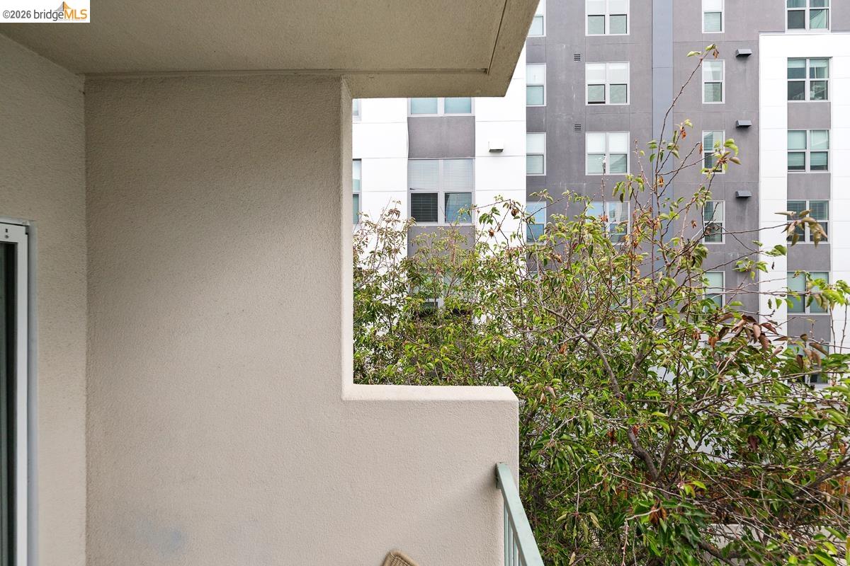 2029 Channing Way, Unit 3D Berkeley, CA 94704 - Photo 53 of 54 Balcony featuring a stucco exterior, a metal railing, and a sliding glass door
