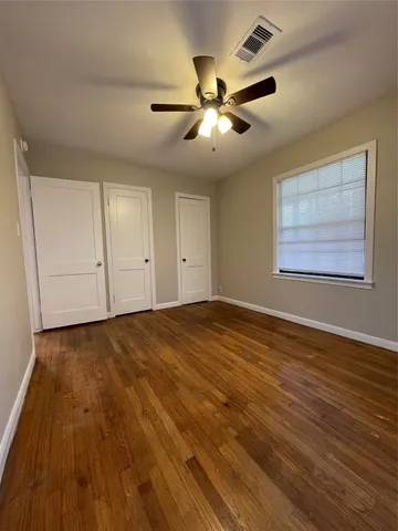 a view of an empty room and wooden floor
