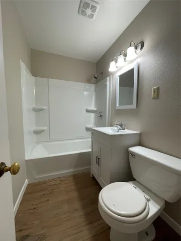 a bathroom with a toilet a sink and bathtub