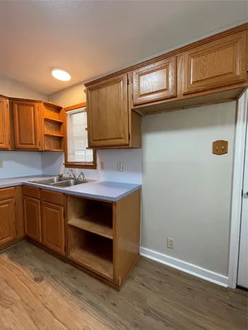 a kitchen with granite countertop cabinets stainless steel appliances and a sink